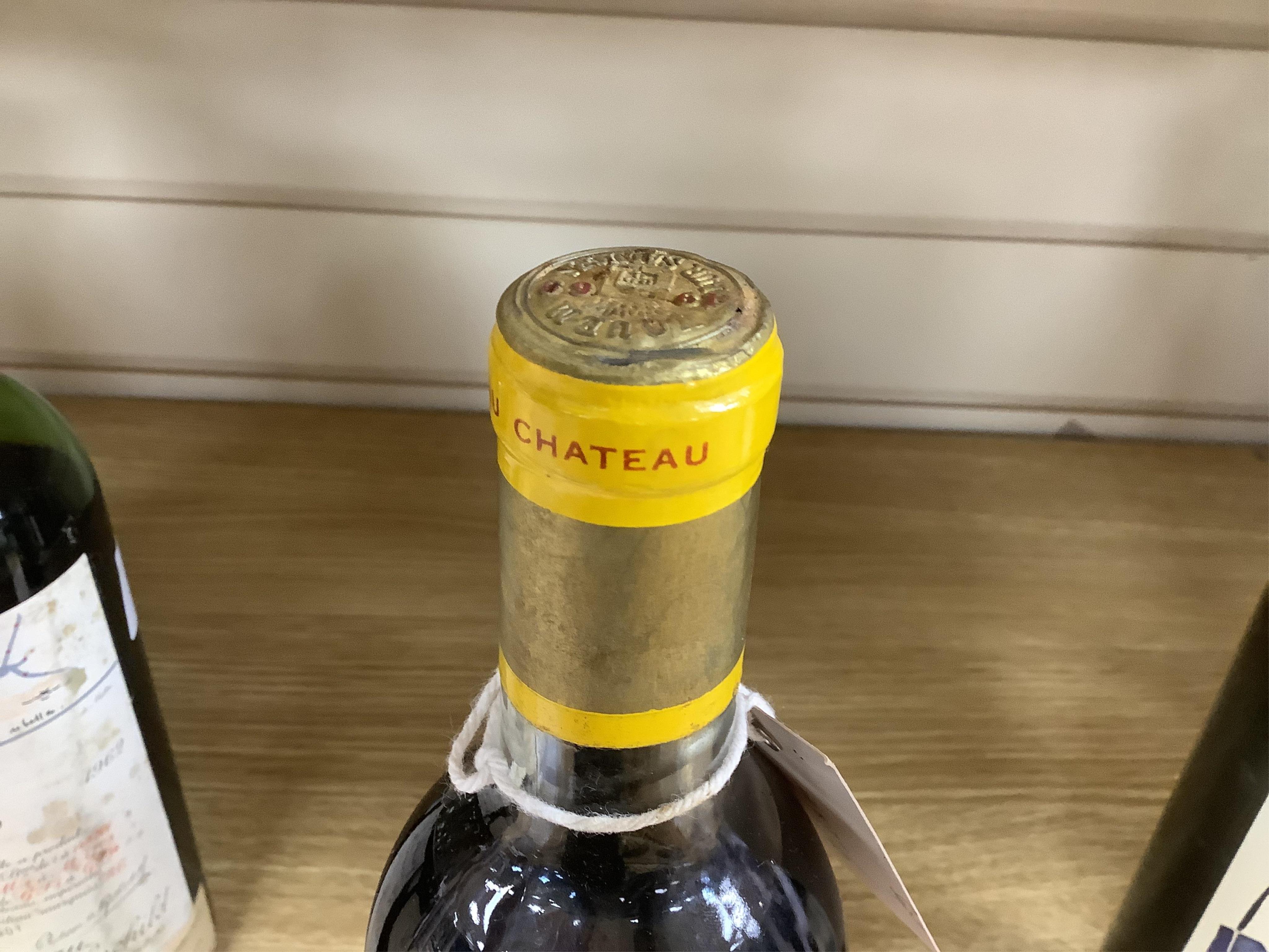 A bottle of Chateau d'Yquem, 1969. Condition - fair, level just above mid shoulder, label poor